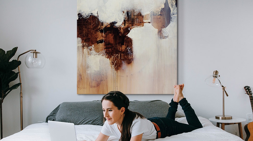 abstract wall art hanging over a bed