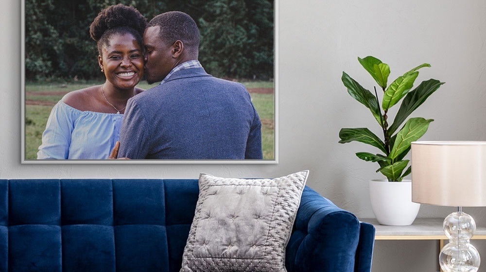 floating frame canvas print of a young couple displayed in a living room