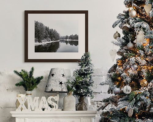 framed photo prints of mother and father with kids hanging over a couch