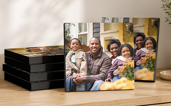 Six stacked canvases on top of a desk
