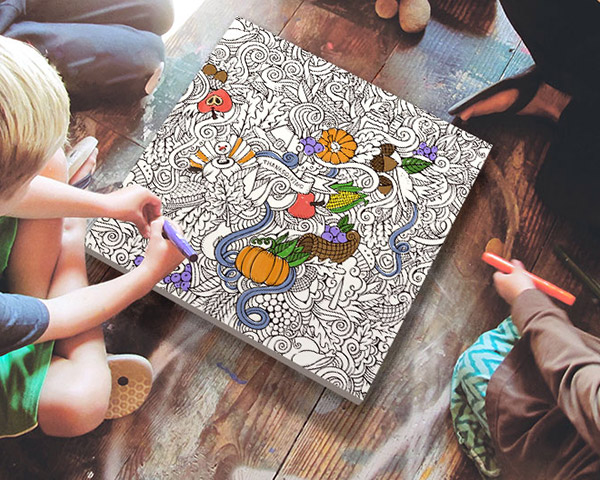 family and children enjoying the activity of decorating a coloring canvas celebrating thanksgiving