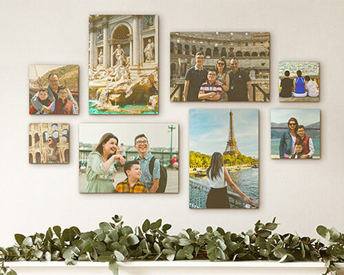 eight canvases of a family arranged into a gallery wall