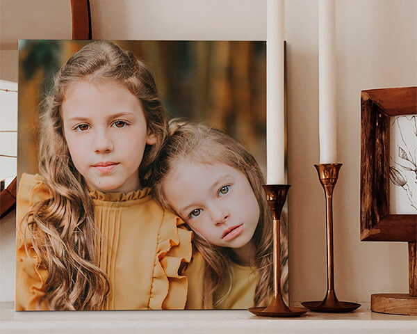 two sisters with one resting their head on the other's shoulder