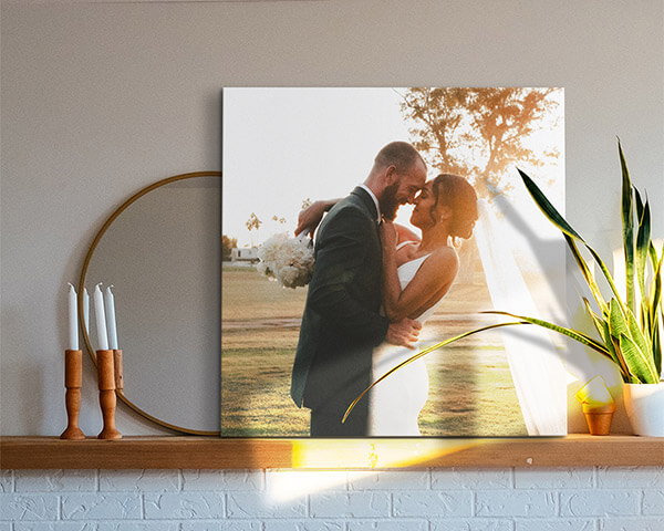 a couple on their wedding day displayed on a mantel