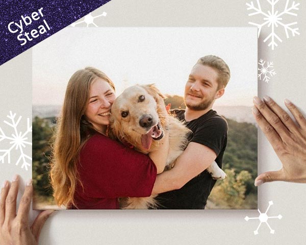 A sweet couple holding their goofy dog