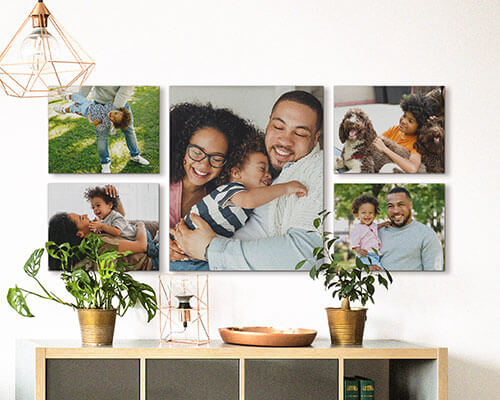 Five canvases of a family arranged into a gallery wall