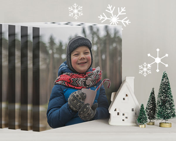 multiple copies of a canvas print of a cute kid, standing up on a table