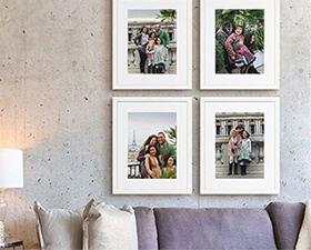 four white framed prints of a family traveling